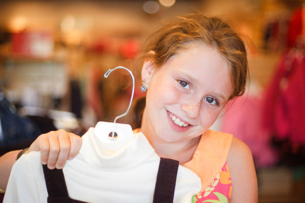 Girl picking out new shirt