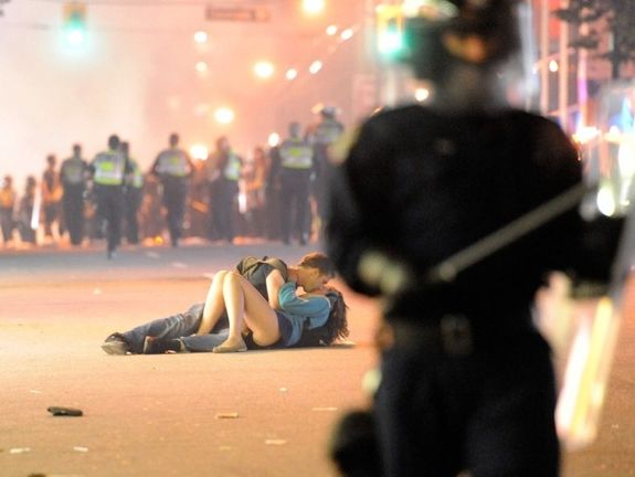 Couple kissing in middle of riot