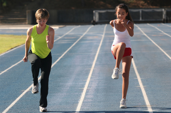 Mom and tween daughter running track