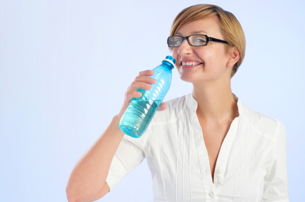 Woman drinking from water bottle