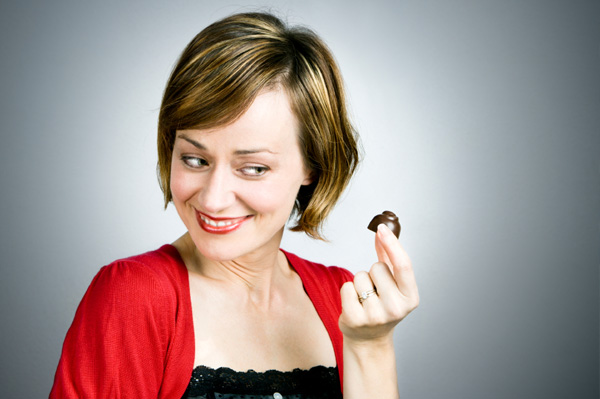 Woman eating dark chocolate