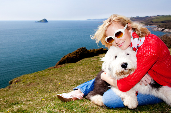 Woman with sheepdog on vacation