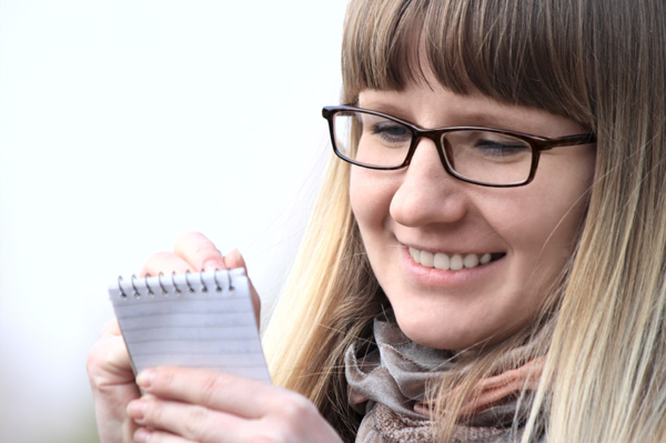 Woman writing notes to herself