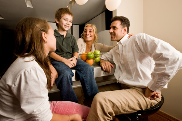 Family talking in kitchen