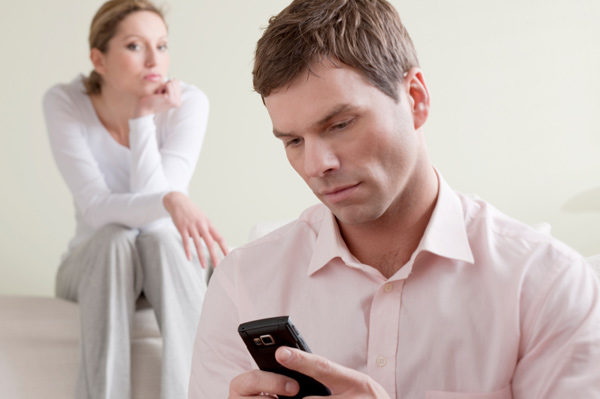 Jealous woman watching husband
