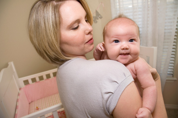 Mom holding baby girl