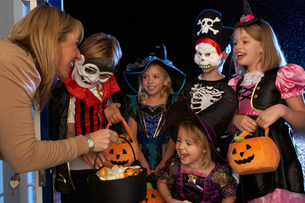 Woman giving kids candy