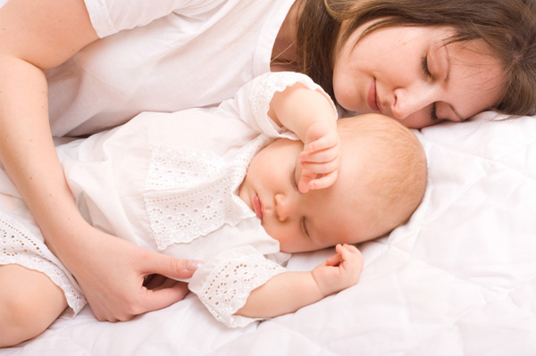 Woman napping with baby