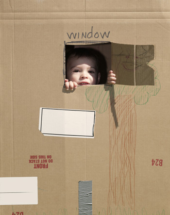 Boy with cardboard fort