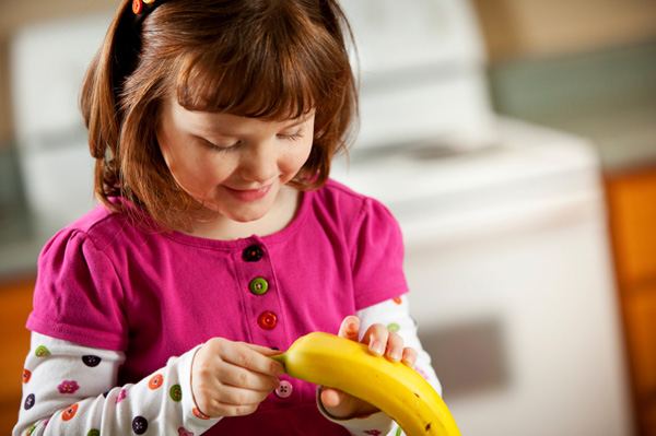 Girl peeling banana