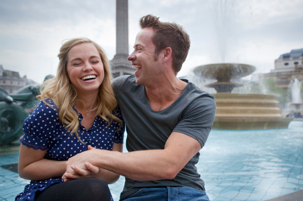 Happy couple laughing outdoors