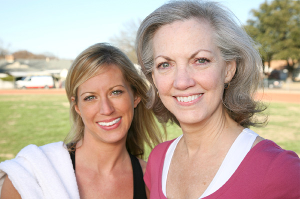 Mature woman and woman in 30s exercising to prevent cancer