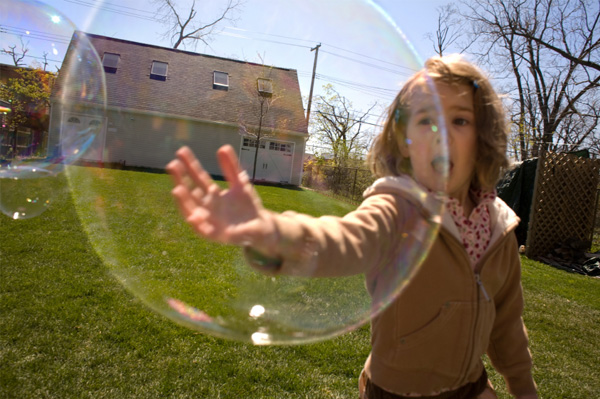 Preschooler playing with bubbles outdoors