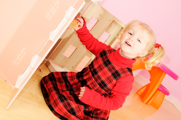 Preschooler putting away her toys