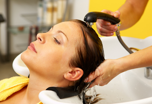 Woman getting hair rinsed at a salon