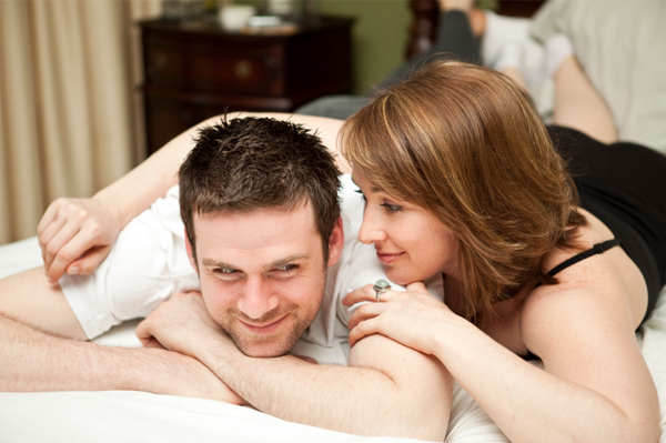 Woman whispering in man's ear