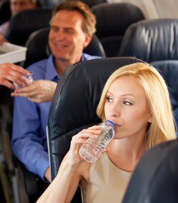 Woman drinking water on a plane