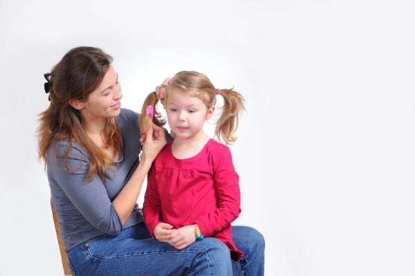 mom-brushing-daughters-hair