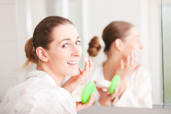 Woman applying anti-aging cream
