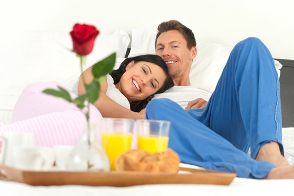 Couple having breakfast in bed