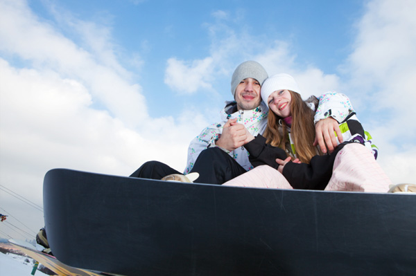 Happy couple snowboarding