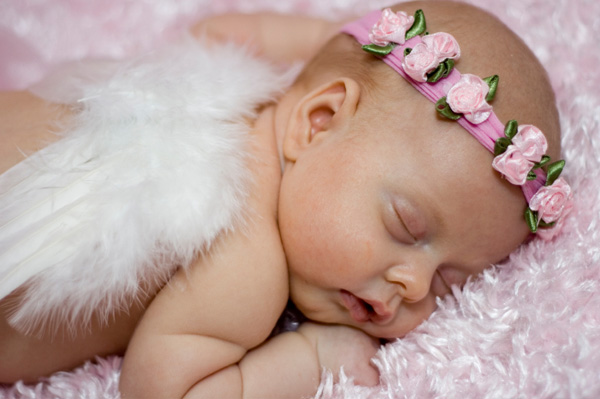 Infant dressed as angel