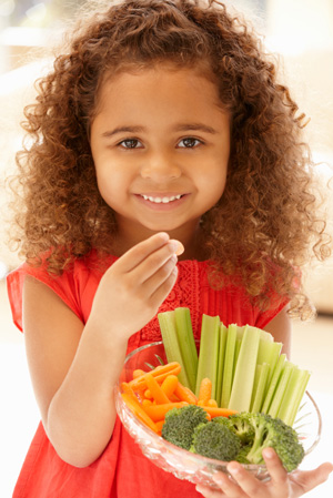 Little girl eating vegetables