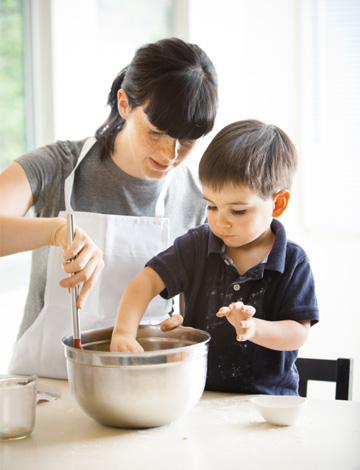 Mom making puppy chow with son