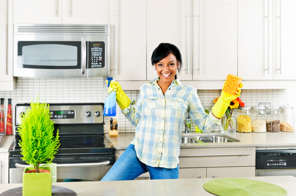 Woman dancing in the kitchen doing chores