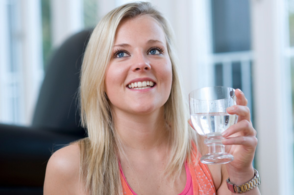 Woman drinking water at holiday party