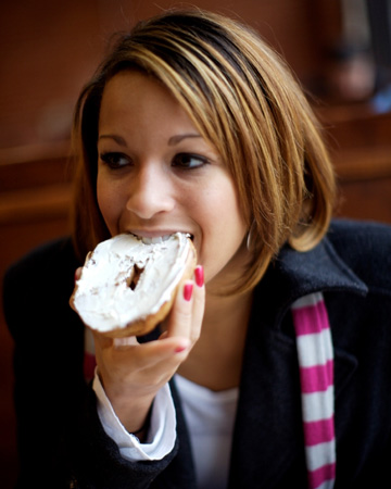 woman-eating-bagel-in-cafe.jpg