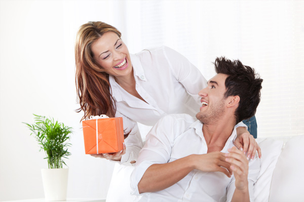 Woman giving gift to boyfriend