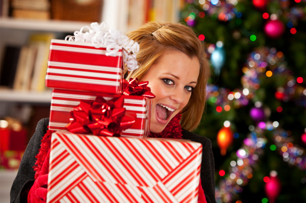 Woman with pile of Christmas gifts