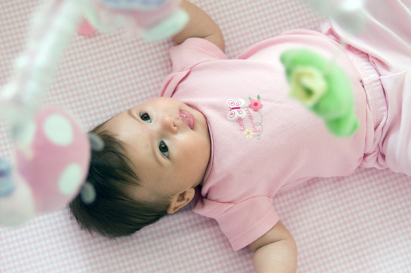 Baby with crib mobile