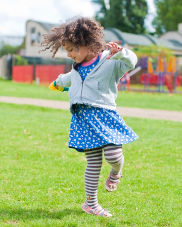 Little girl dancing outside