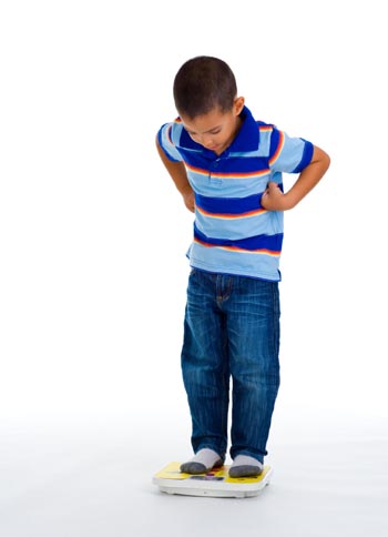 School age boy on scale
