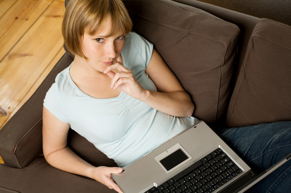 Woman thinking on laptop