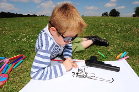 Boy drawing picture of gun