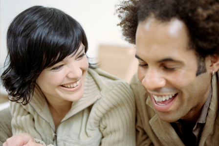 Couple laughing on bed