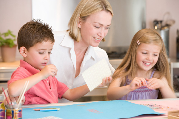 mom and kids doing crafts