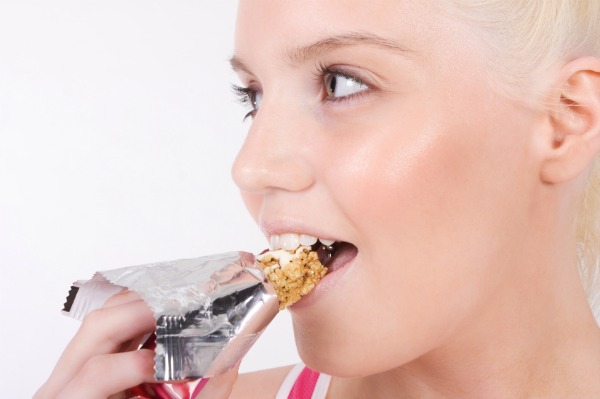 Woman eating a granola bar