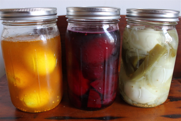 Eggs pickling in colorful brines
