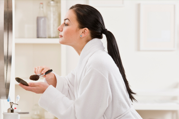 Woman applying makeup