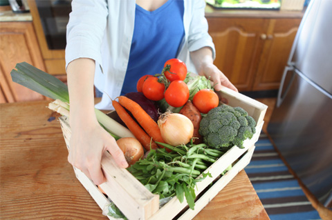 Woman with CSA veggies