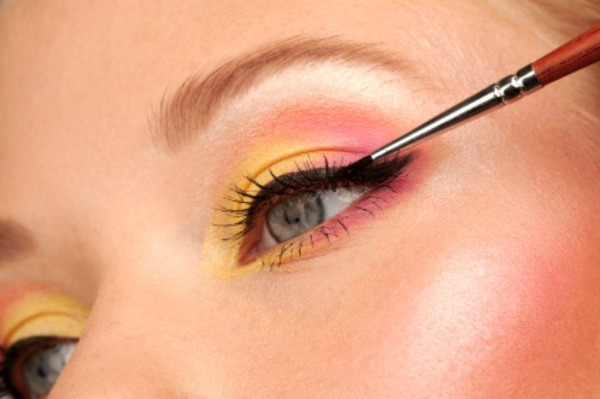 Applying eyeliner