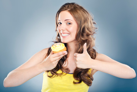 Happy woman with cupcake