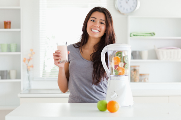 Healthy woman making smoothie