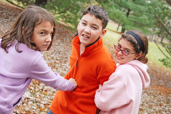 two kids picking on a single kid