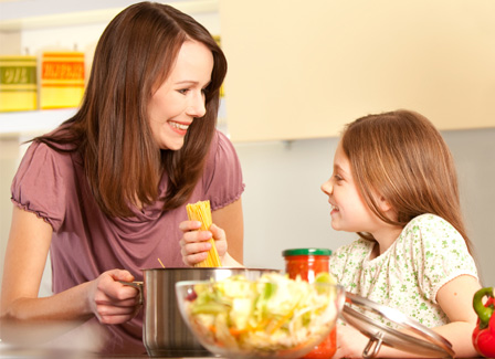 Mom and daughter making pasta