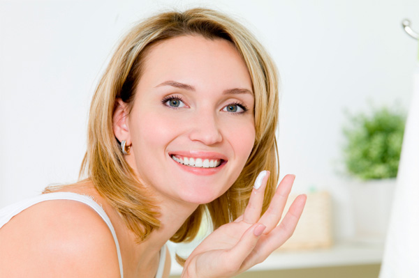 Woman applying face cream